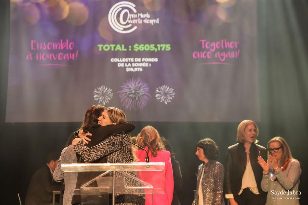 Aphrodite Salas hugging someone at an event