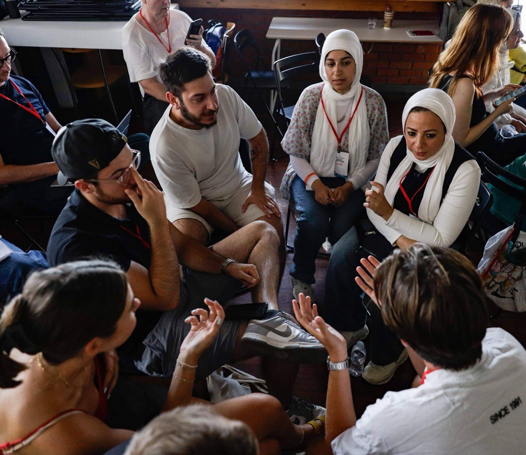 Group of people in conversation in a circle